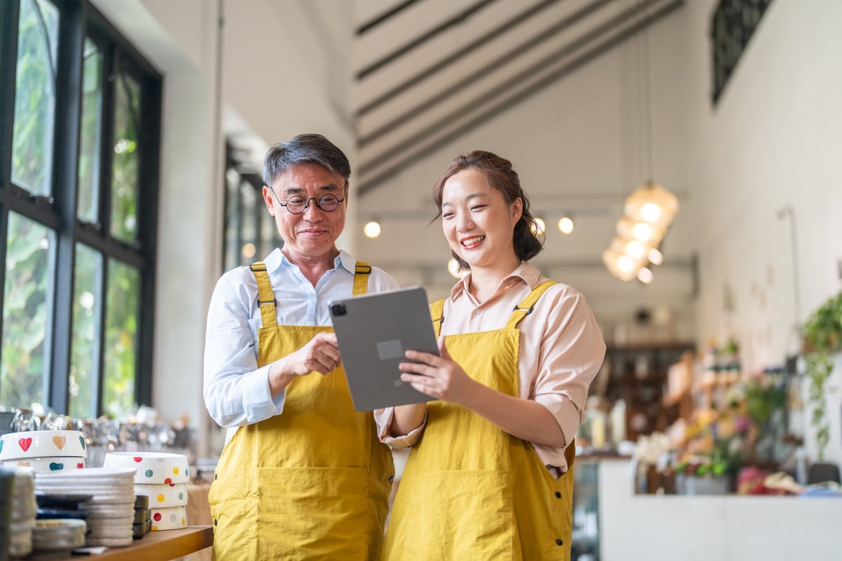 Small business owners checking stock together at their local retail store