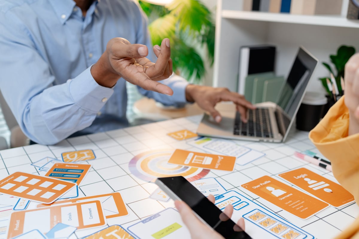 UX designer presenting wireframes and interface layouts during a collaborative design workshop